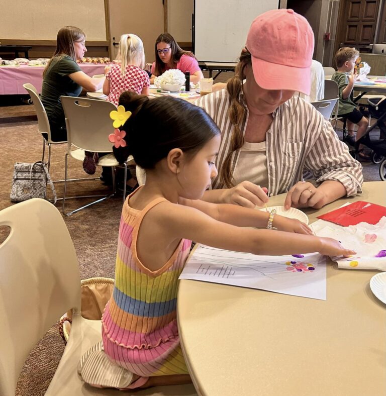 Photo of preschool kid and adult doing arts and crafts together